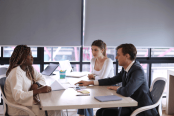 Employees discussing user feedback survey results for improved product development.