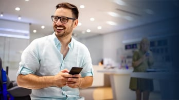 happy man in office on his phone