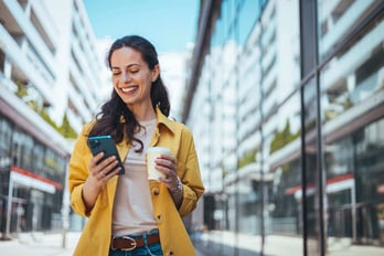 happy woman receiving a gift card reward on her phone