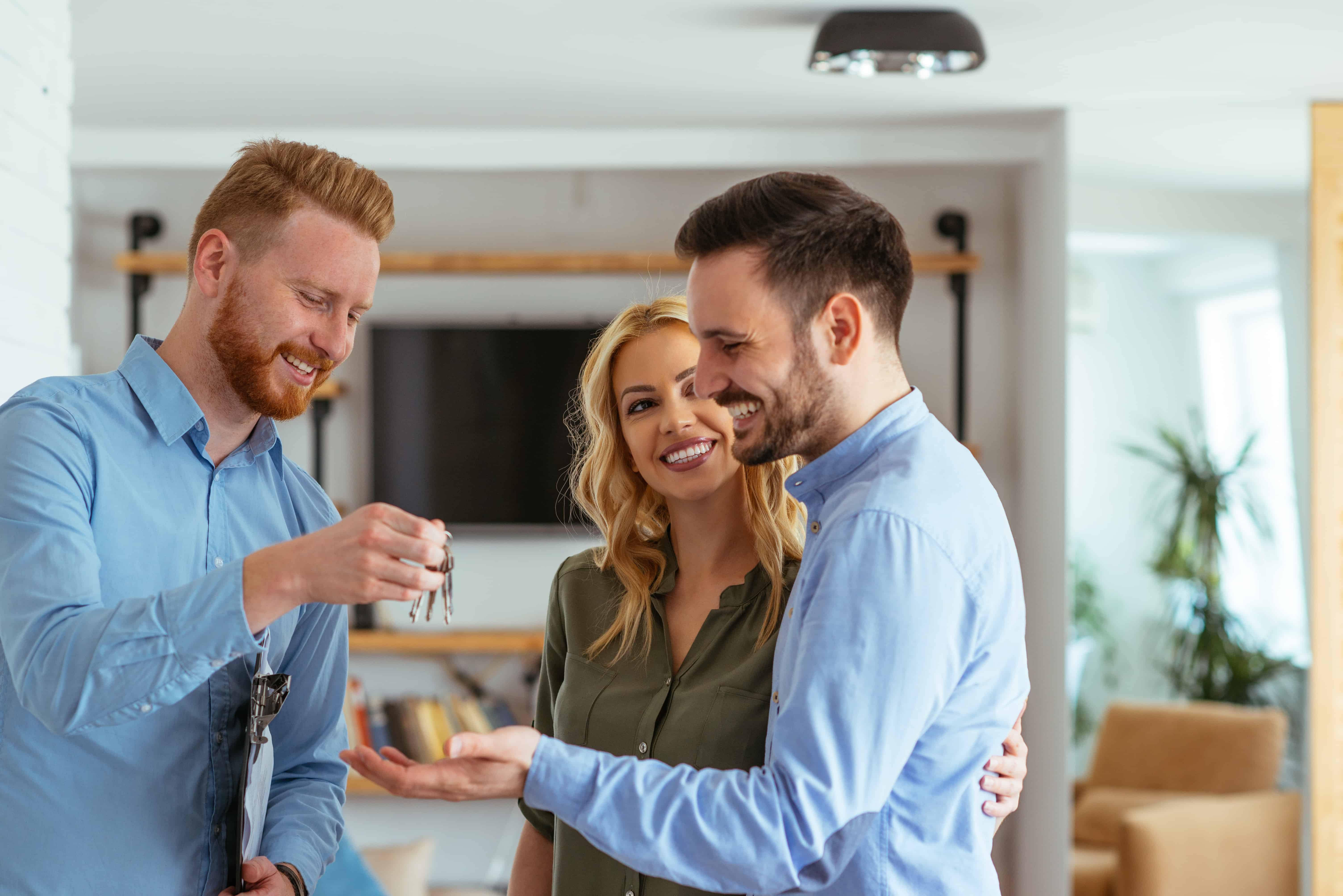 OPT Blog Image - Couple celebrating house purchase with a referred real estate agent