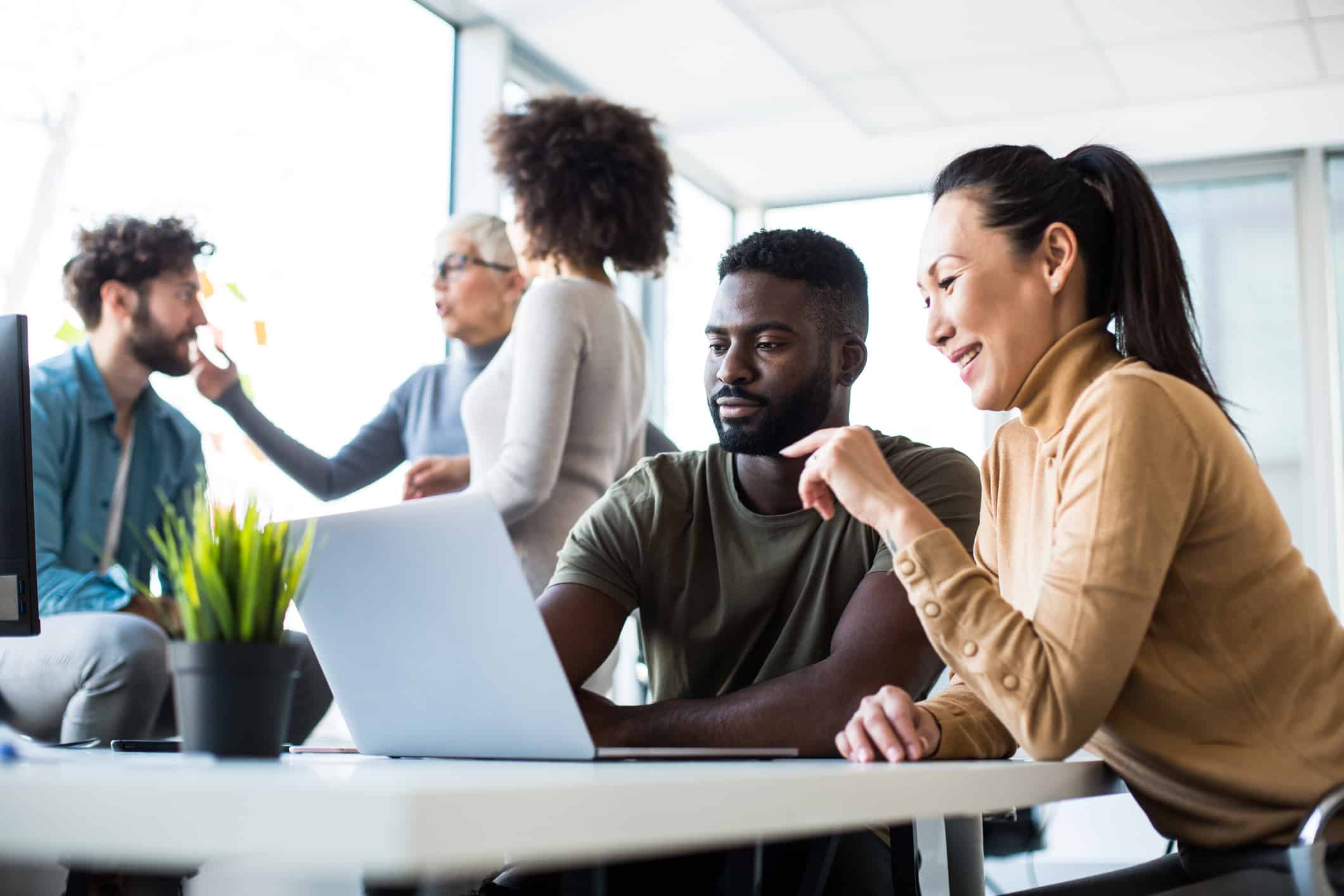 happy employees working together at a laptop