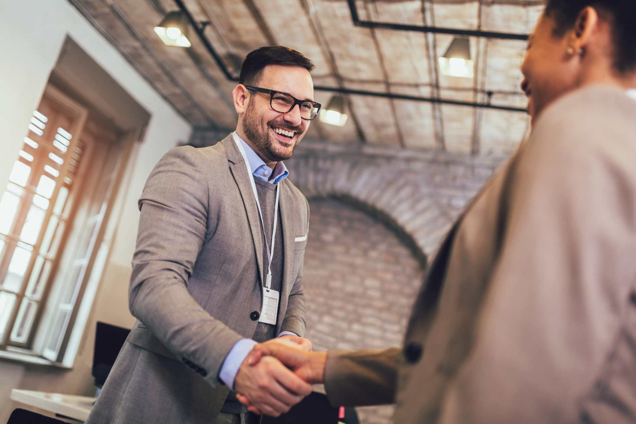 incentivized salesman making a sale and shaking hands