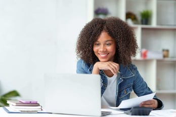 professional woman using her laptop to assess an online gift card provider